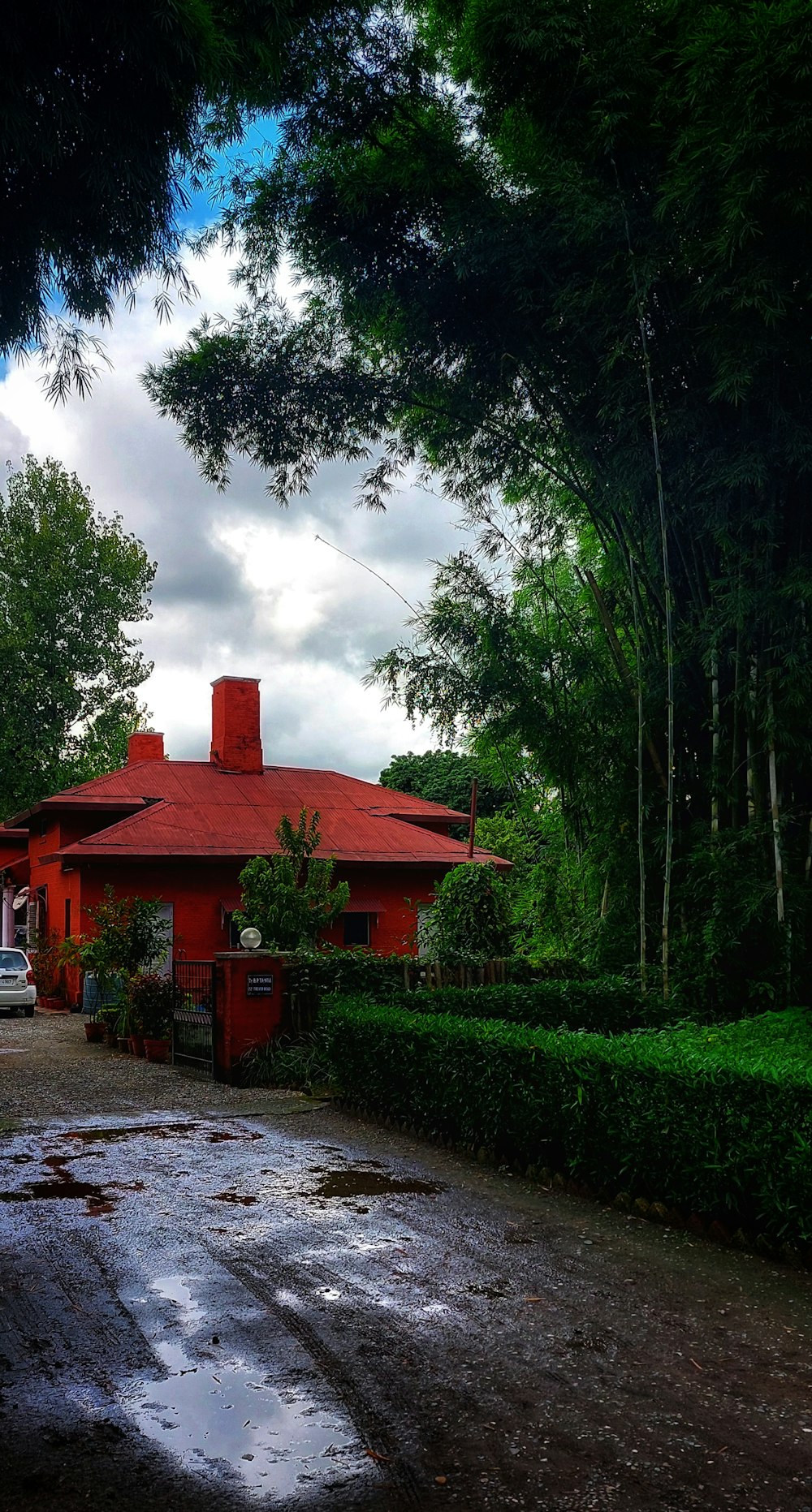 a red house with a red roof surrounded by trees
