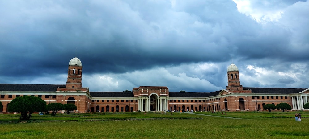 a large building with a green lawn