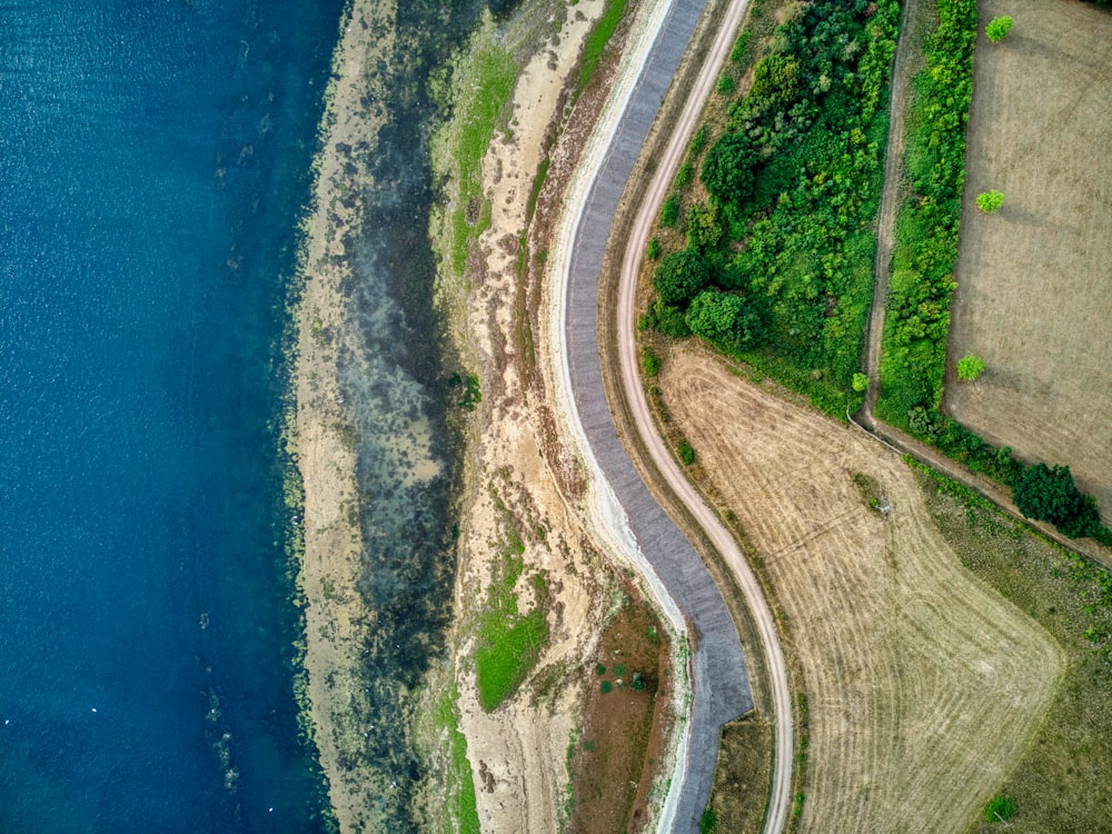 a road next to a body of water