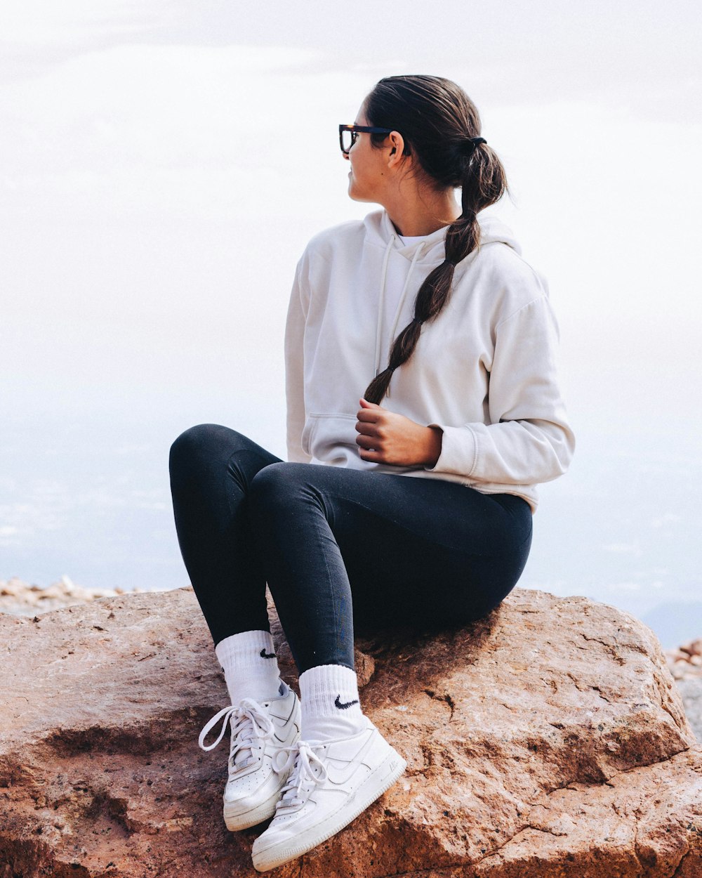 a person sitting on a rock