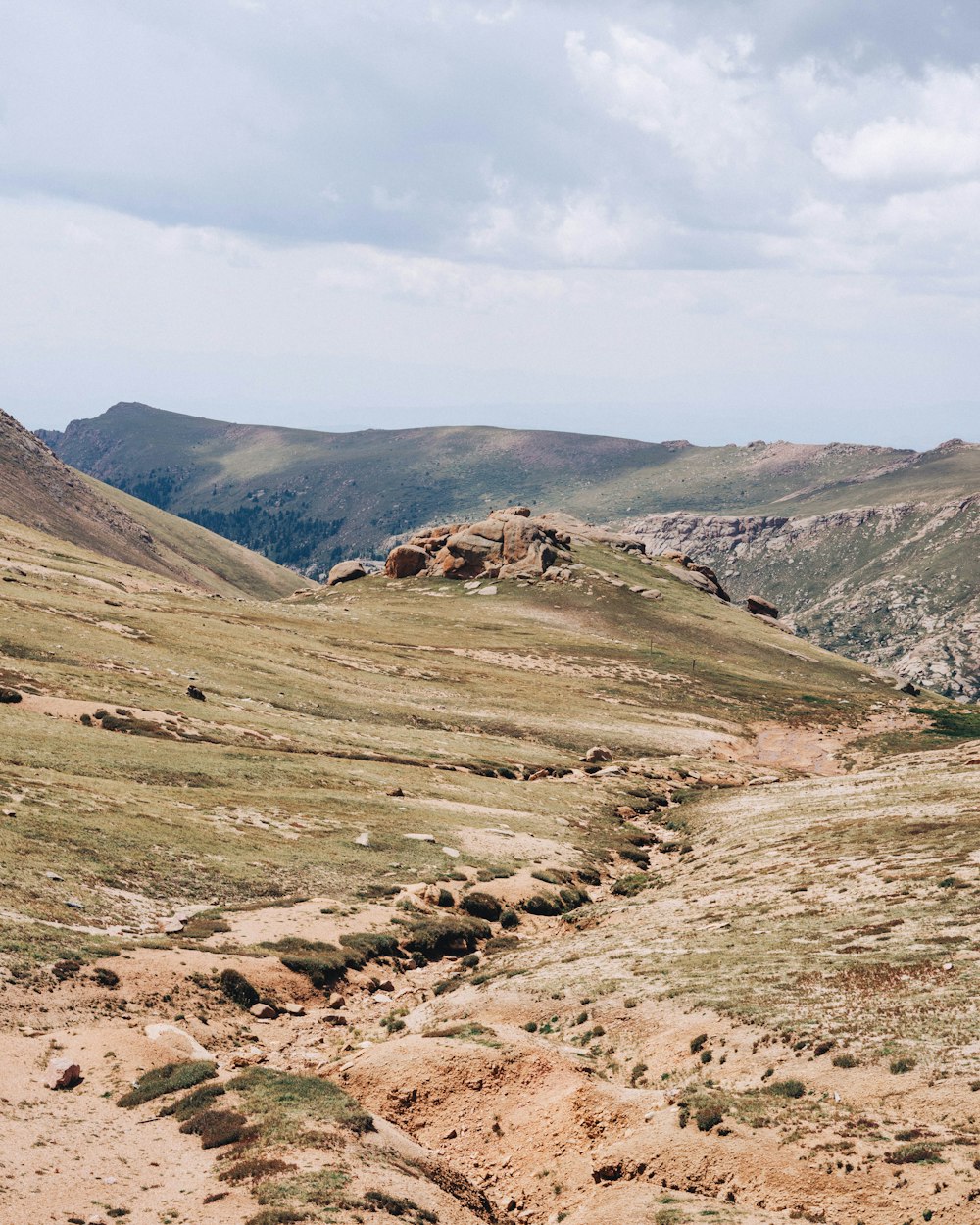 a rocky landscape with a hill in the background