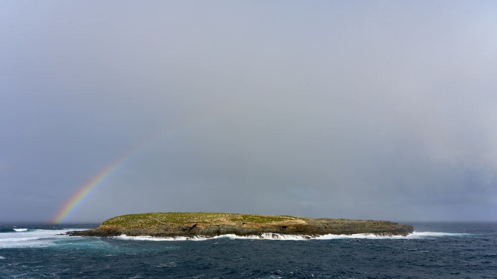 a rainbow over a small island