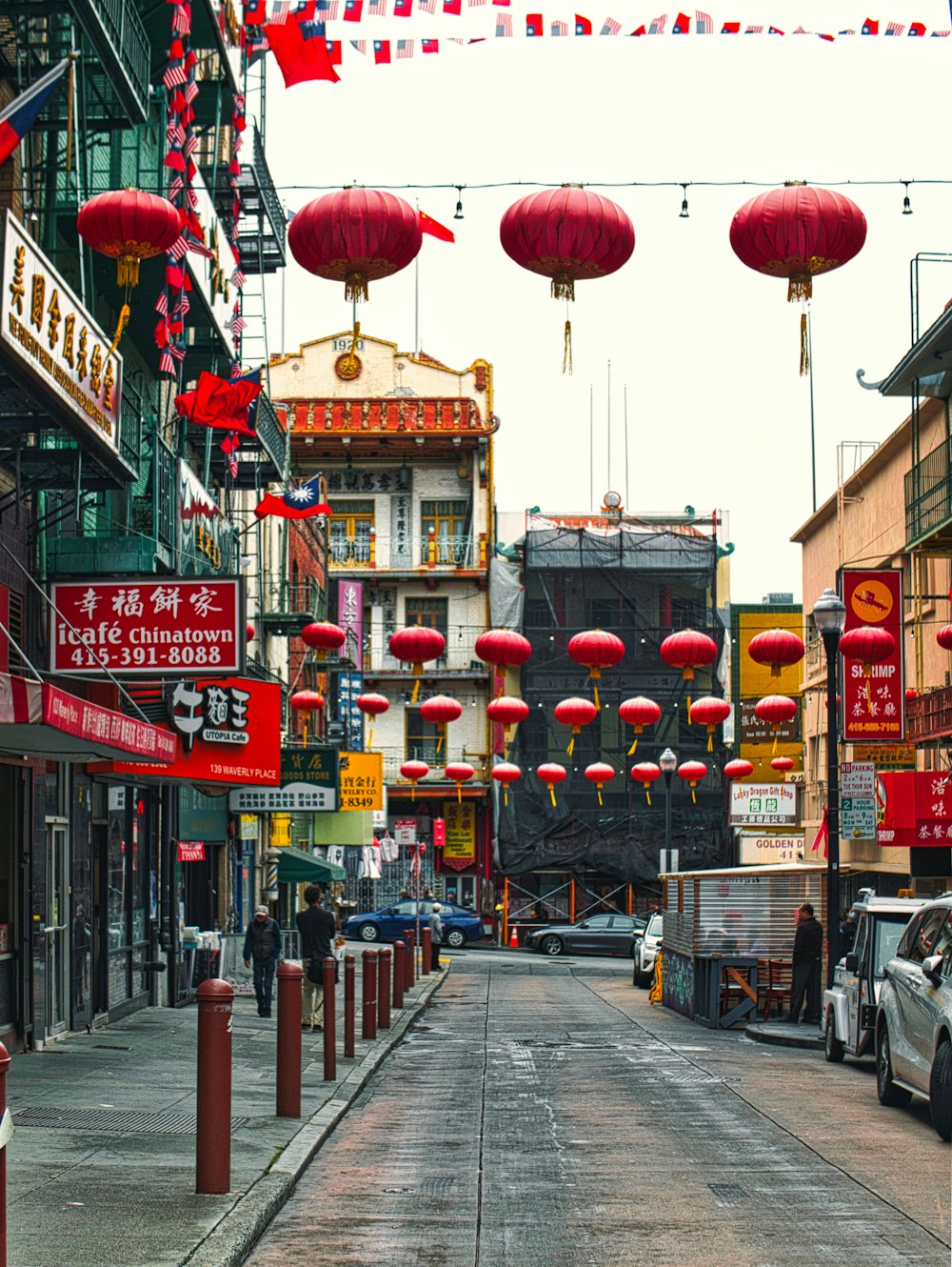 a street with buildings and lanterns