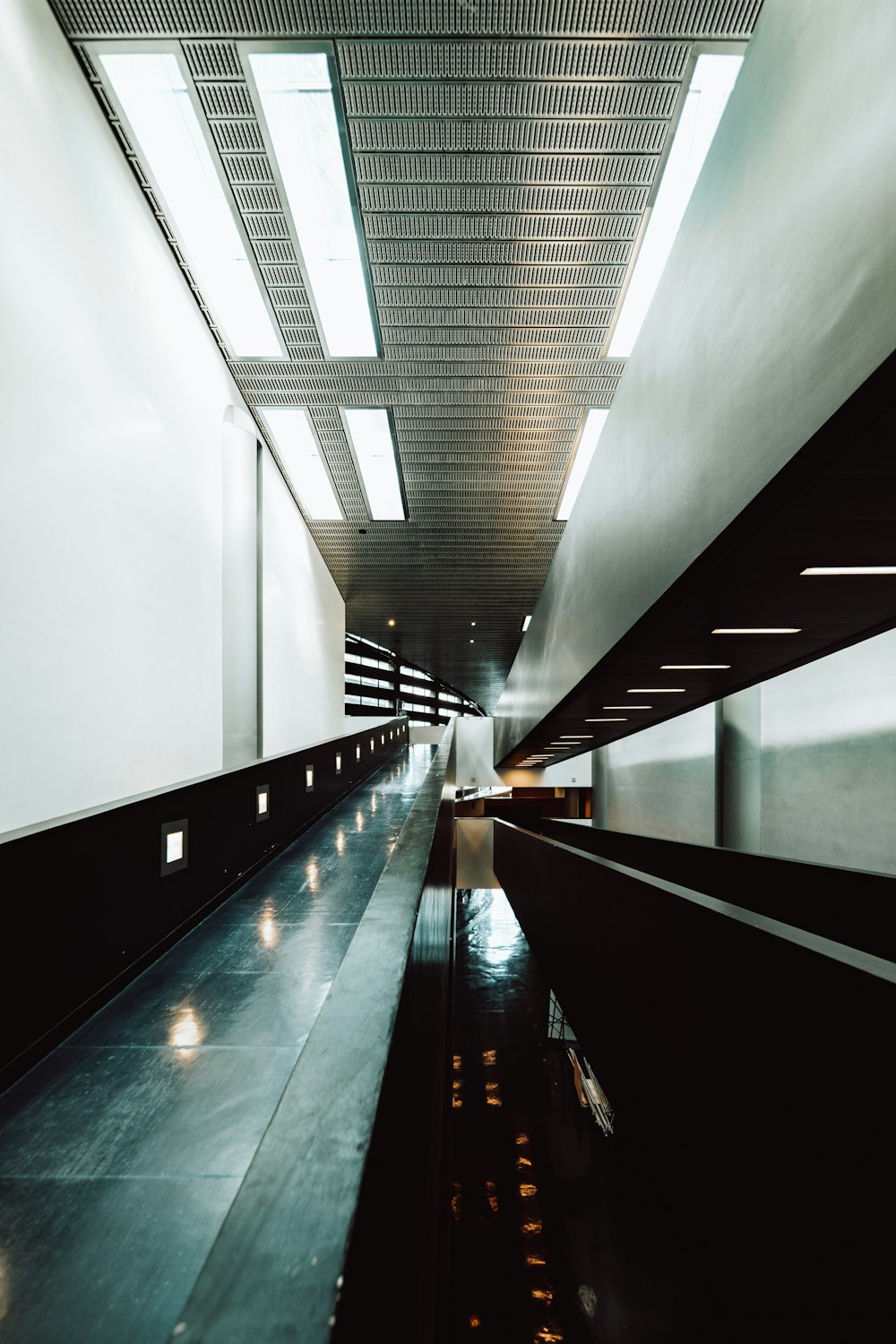 a long hallway with a light on the end