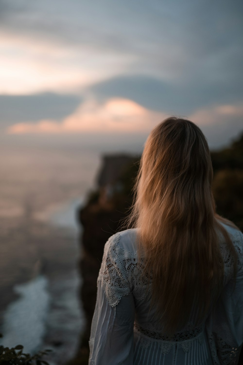 a woman looking at a sunset