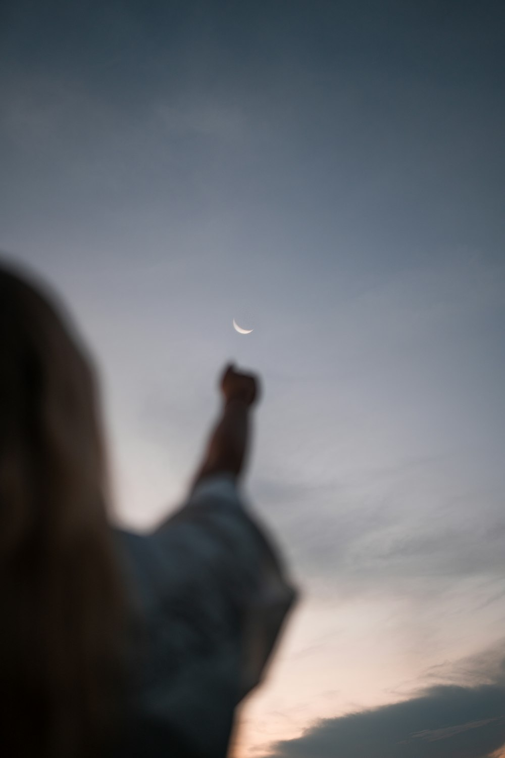 a person reaching for a moon