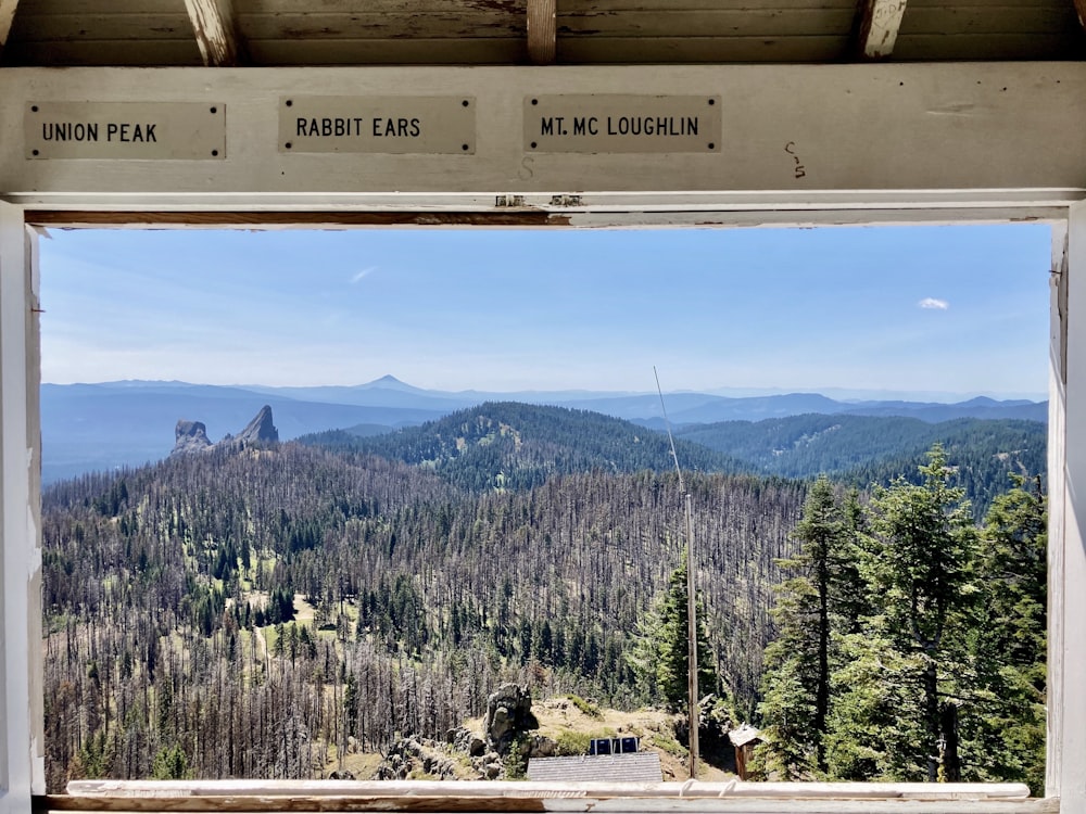 a view of a mountain range from a window