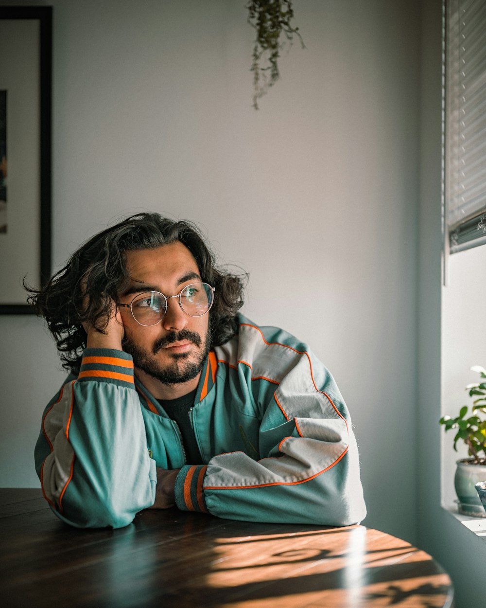 a man with a beard sitting at a table