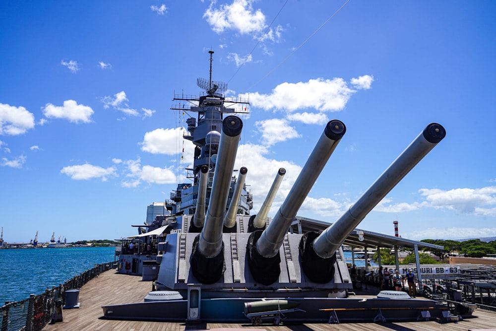 a large ship with pipes on it with USS Missouri (BB-63) in the background