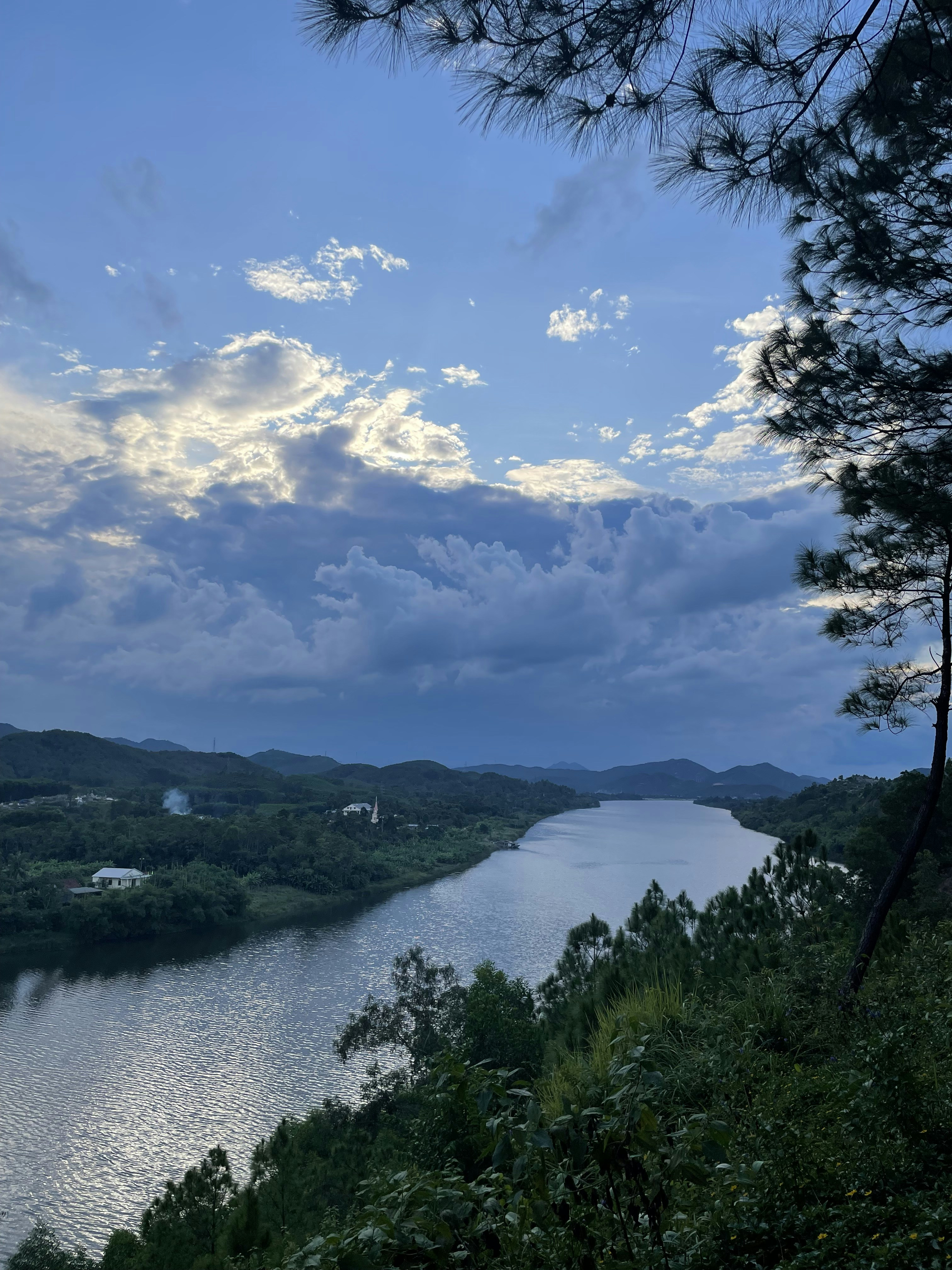 a river with trees and hills around it