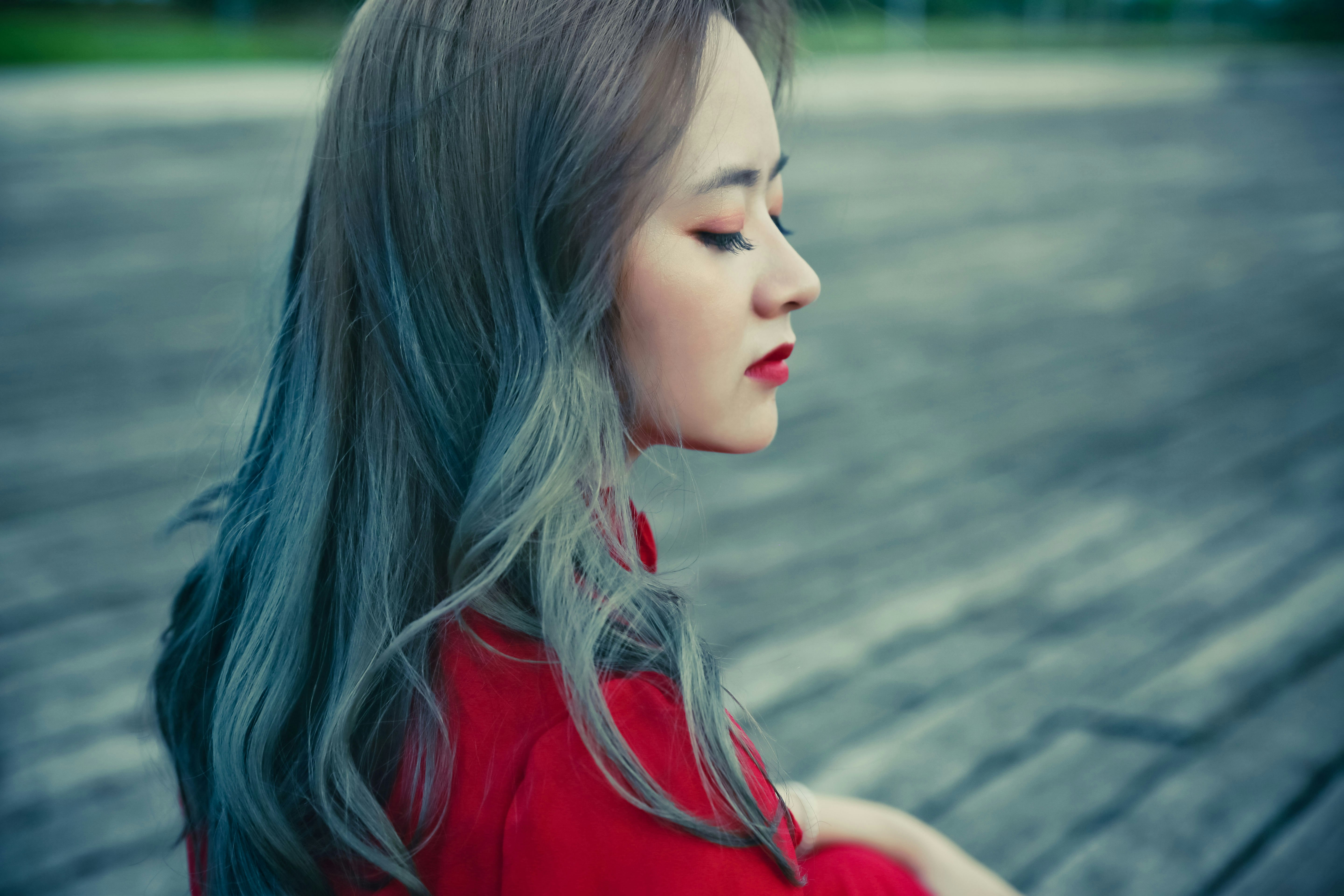 Long, wavy smoky blue-grey hair, seen in profile
