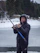 Angler proudly holding a large pike bass caught on a misty Swedish lake at dawn.
