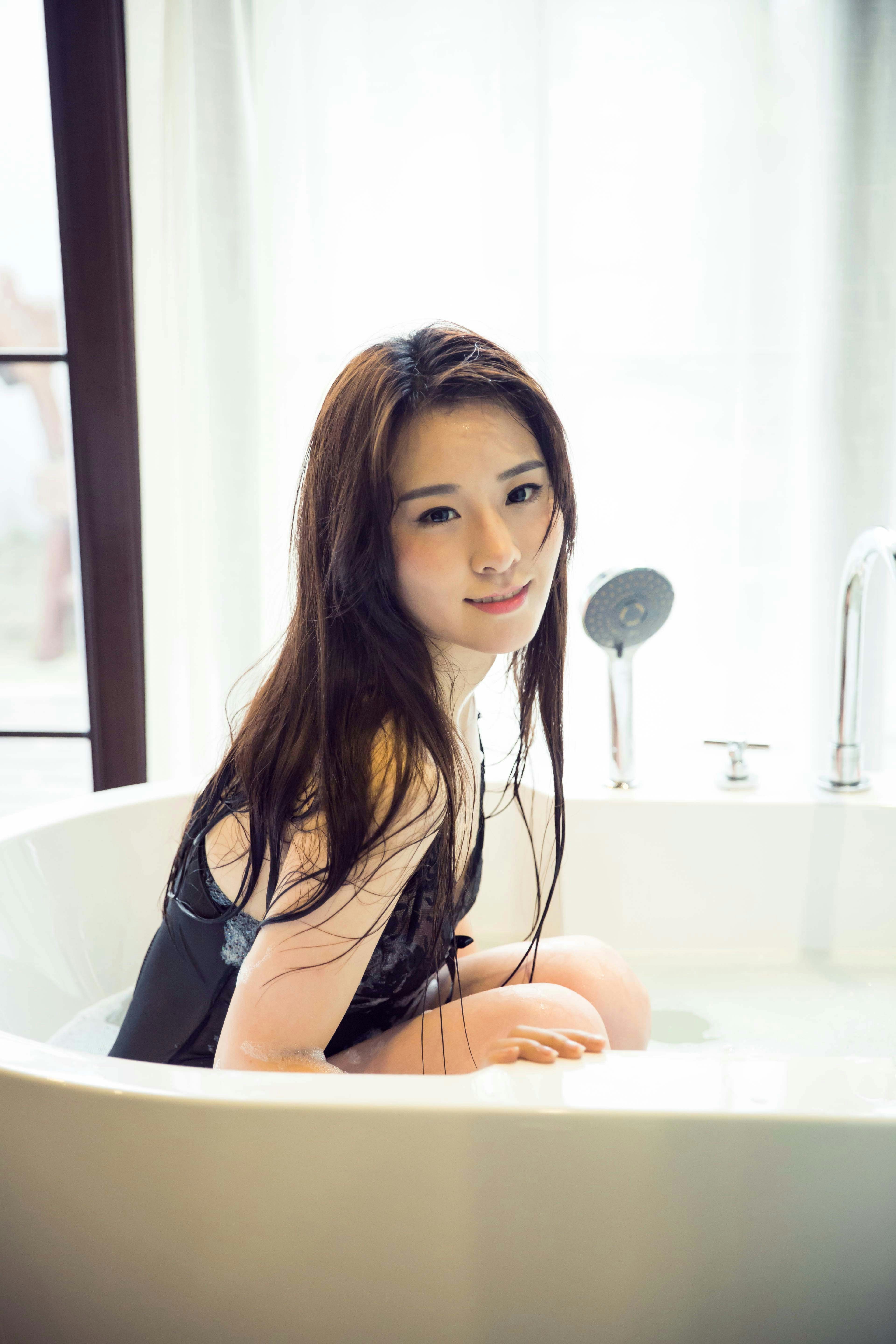 a woman sitting in a bathtub