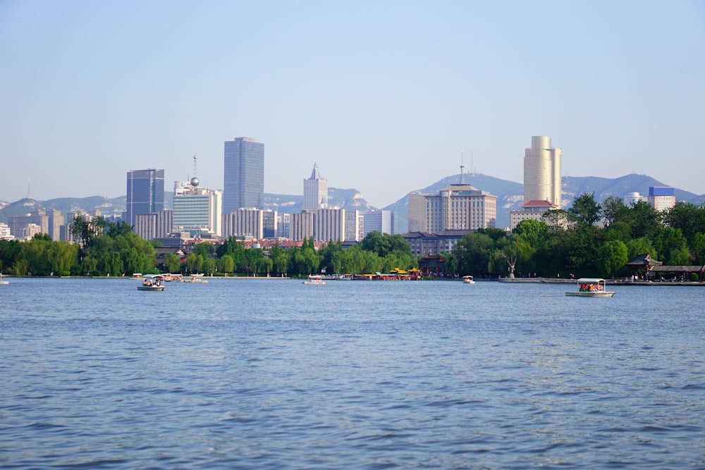 a body of water with boats and buildings in the background