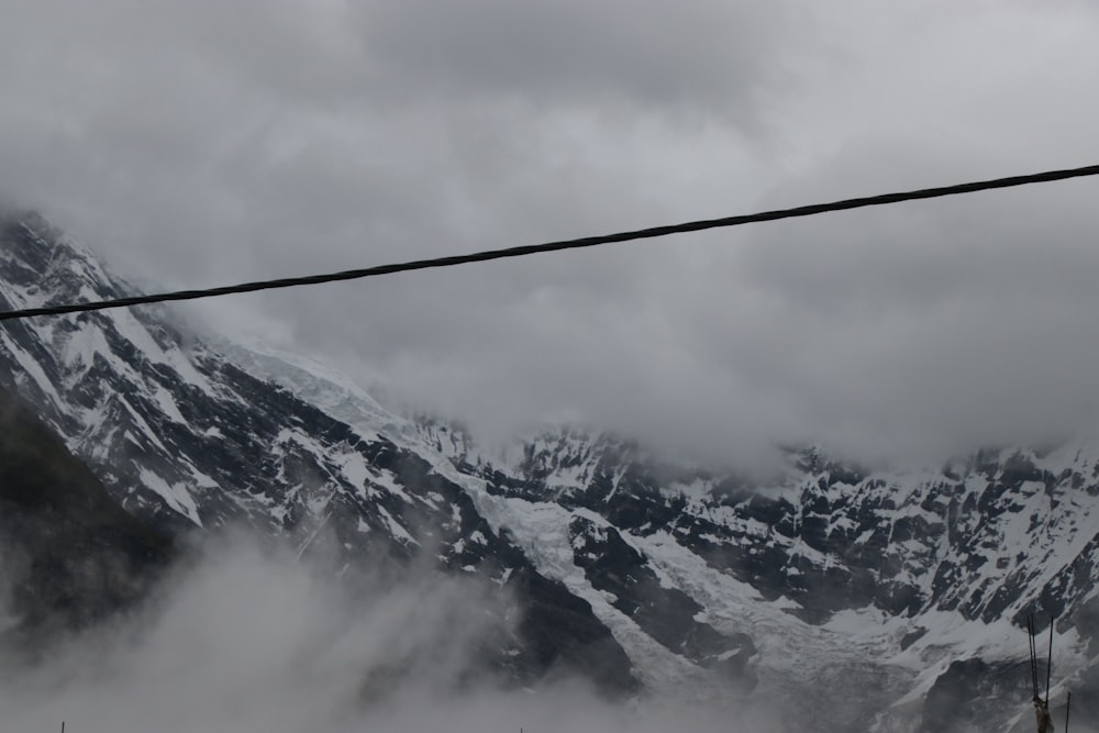 a snowy mountain with clouds