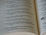 An open book displaying a list of numbered sentences with religious or philosophical content printed in a clear font. The focus is on paragraphs numbered 8 to 18 with some emphasis on certain words through bold text.