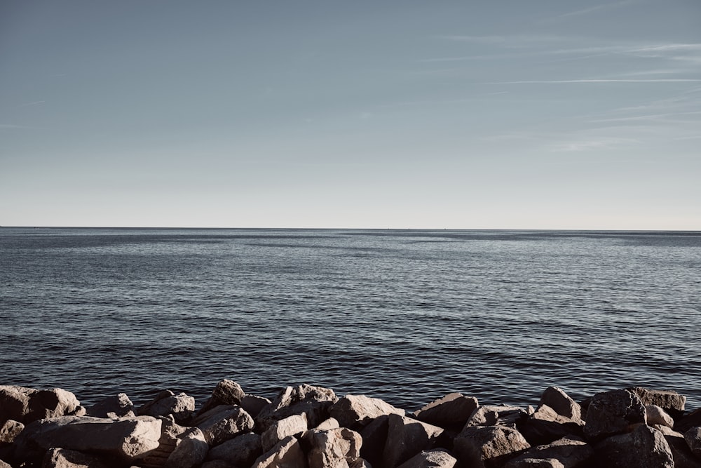 a rocky beach with water in the background