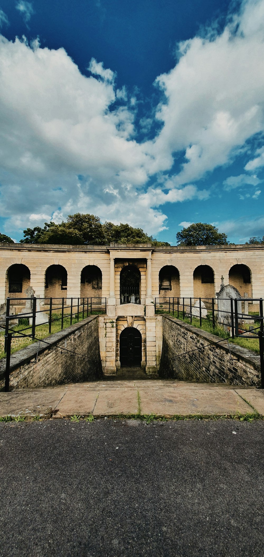 a stone bridge with arches and a fence