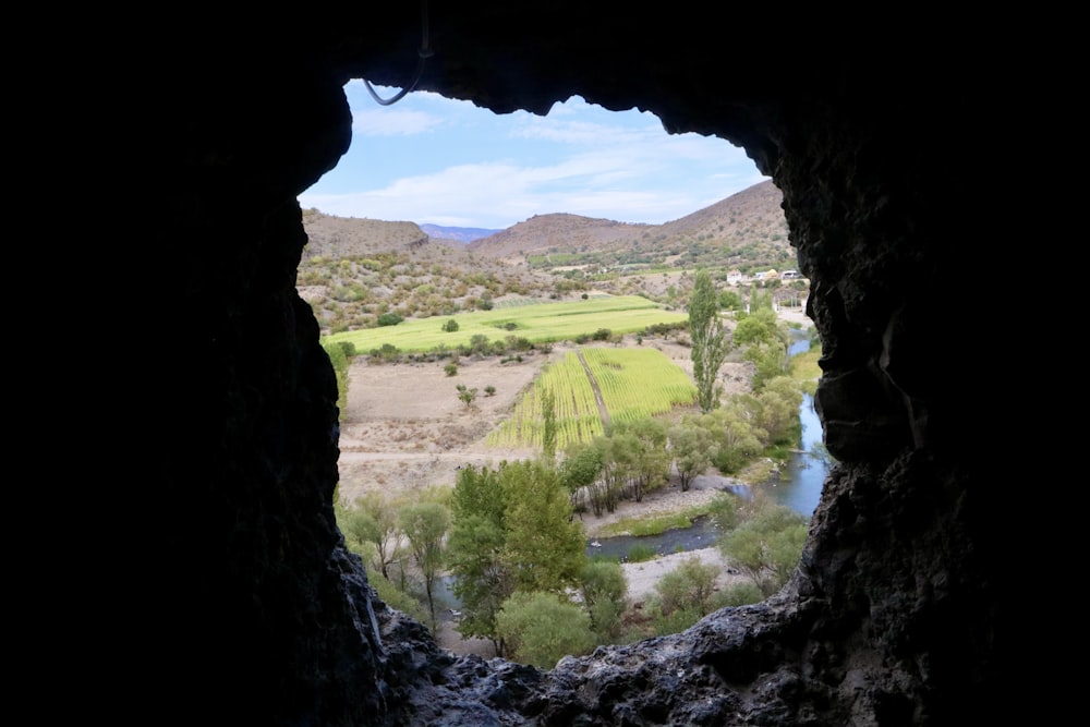 a view of a valley from a cave