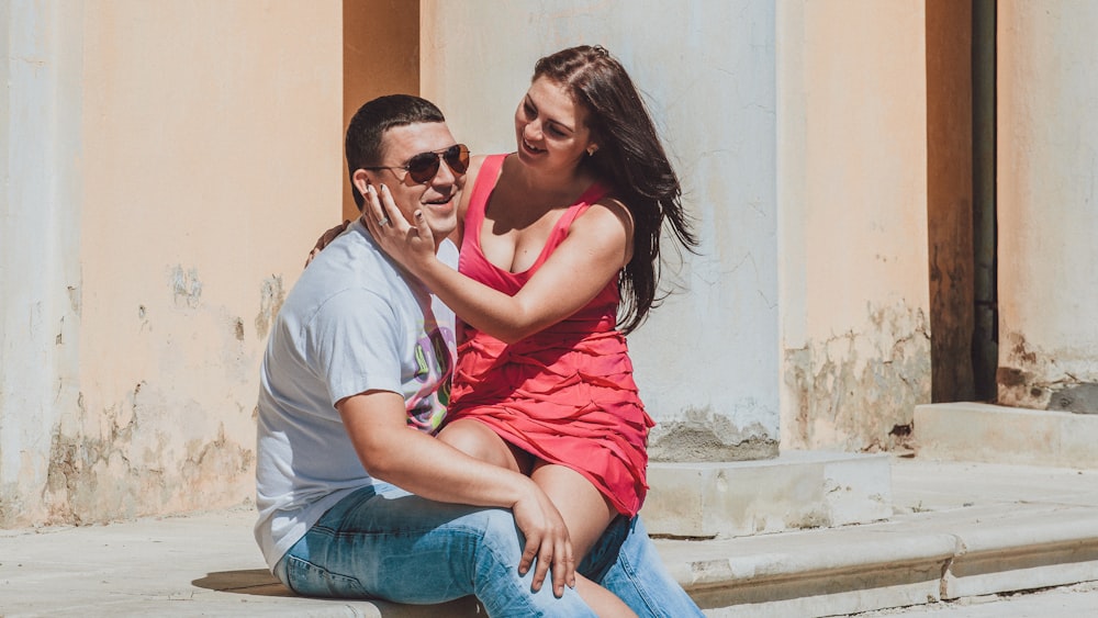 un uomo e una donna seduti su una sporgenza