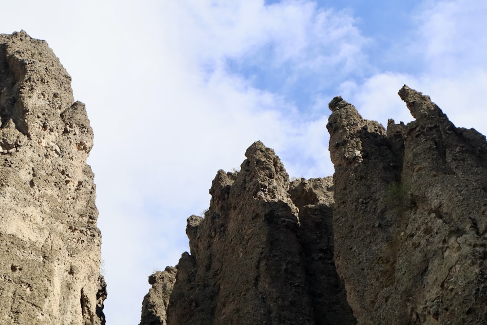 a rocky cliff with a blue sky