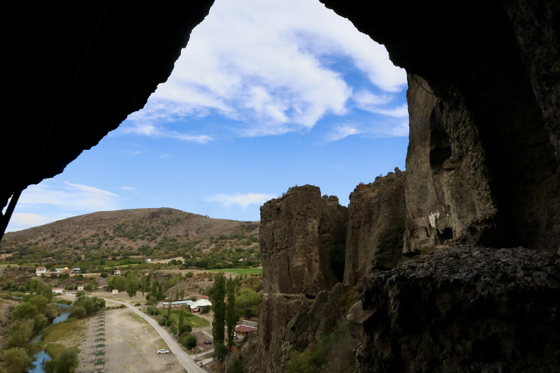 woman wearing yellow long-sleeved dress under white clouds and blue sky during daytime