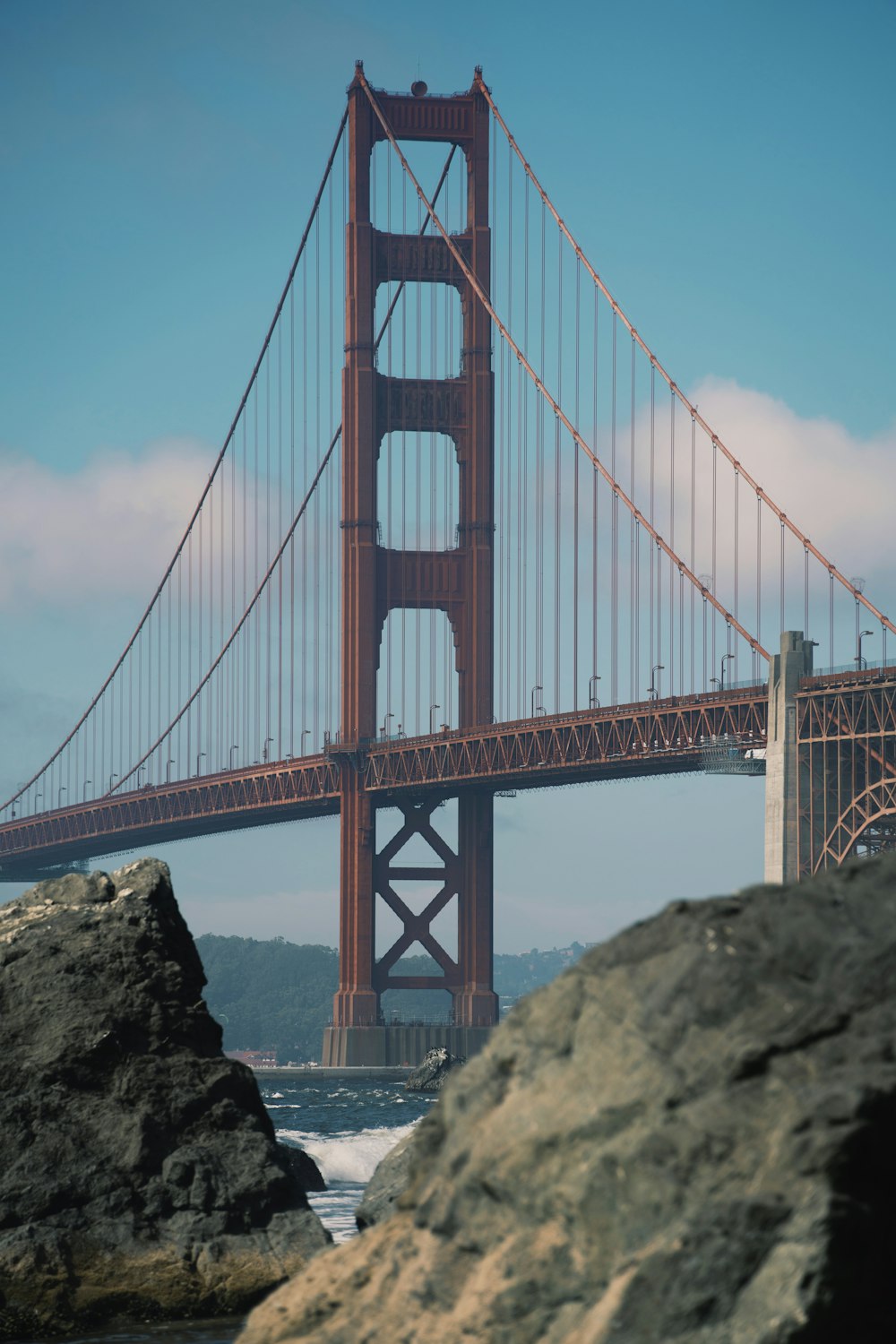 a large red bridge with Golden Gate Bridge in the background