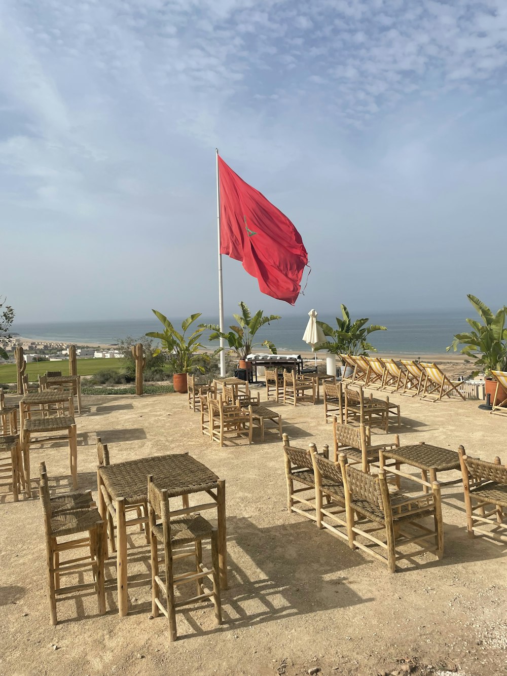 a beach with tables and chairs