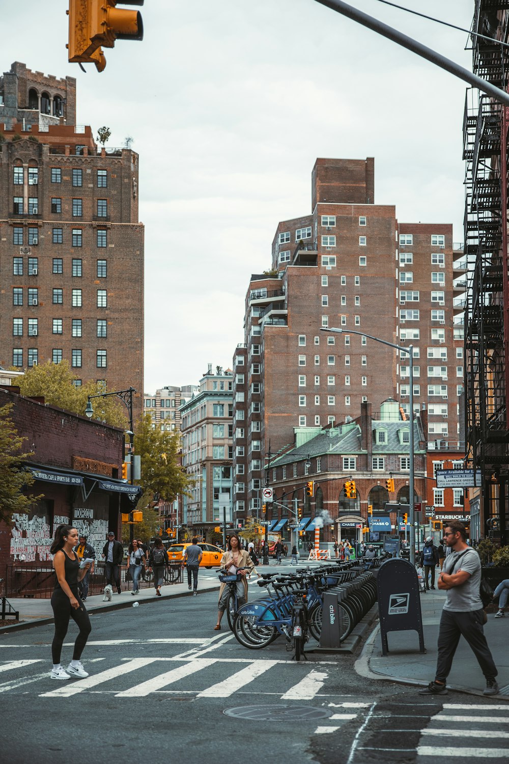 a group of people walk across a crosswalk