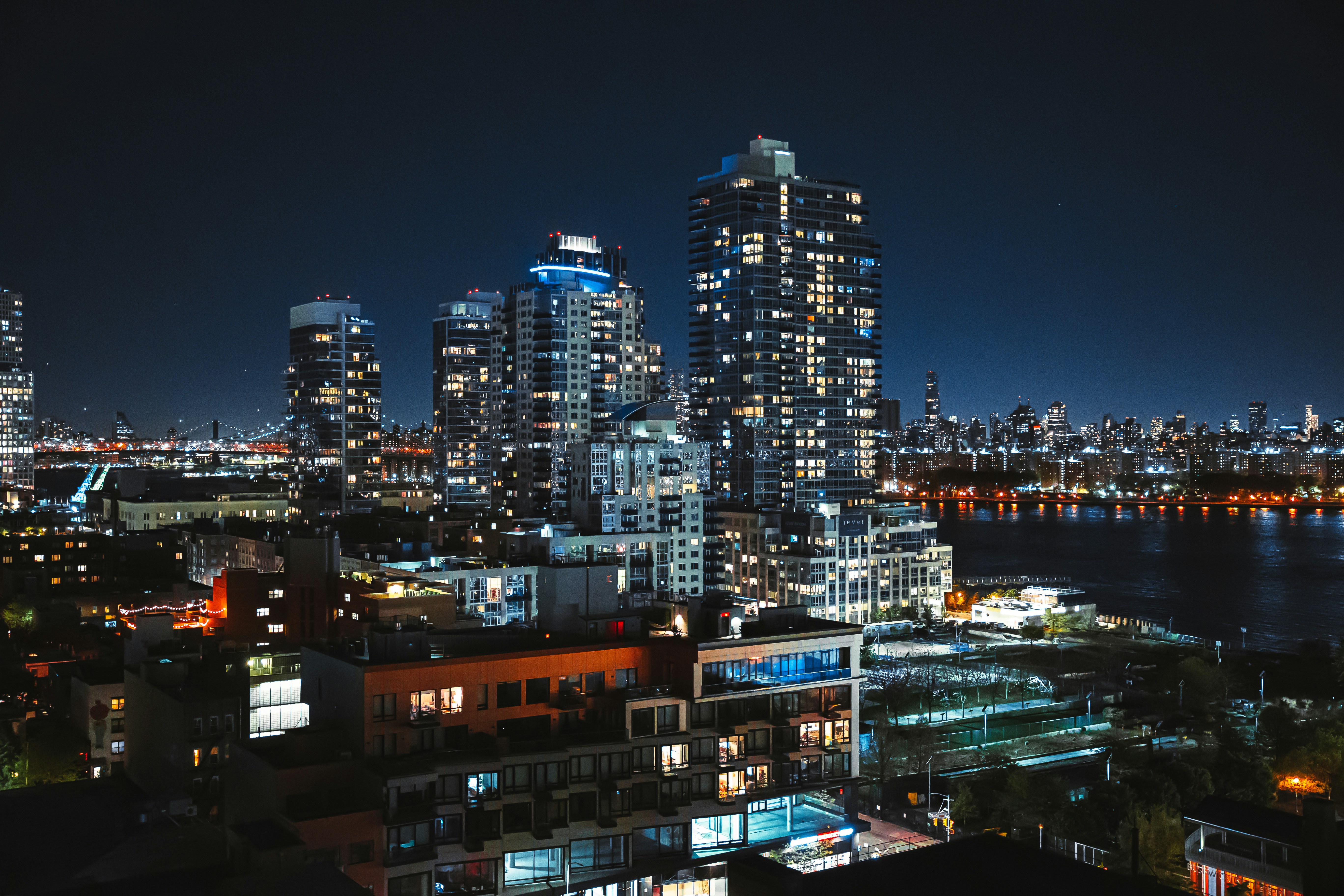 person walking on bridge with roof near building during daytime