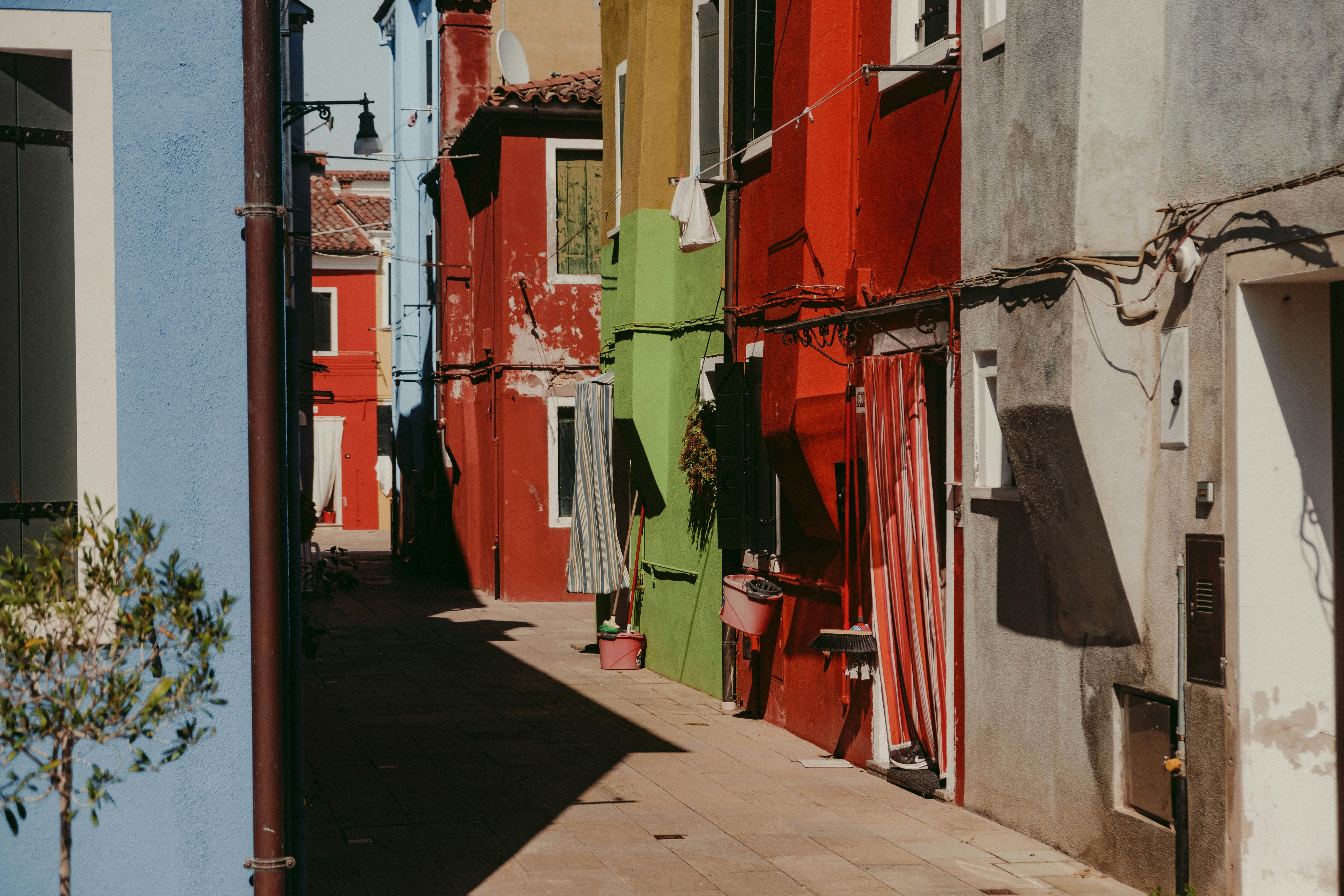 a row of buildings with red and white clothes from the outside, 