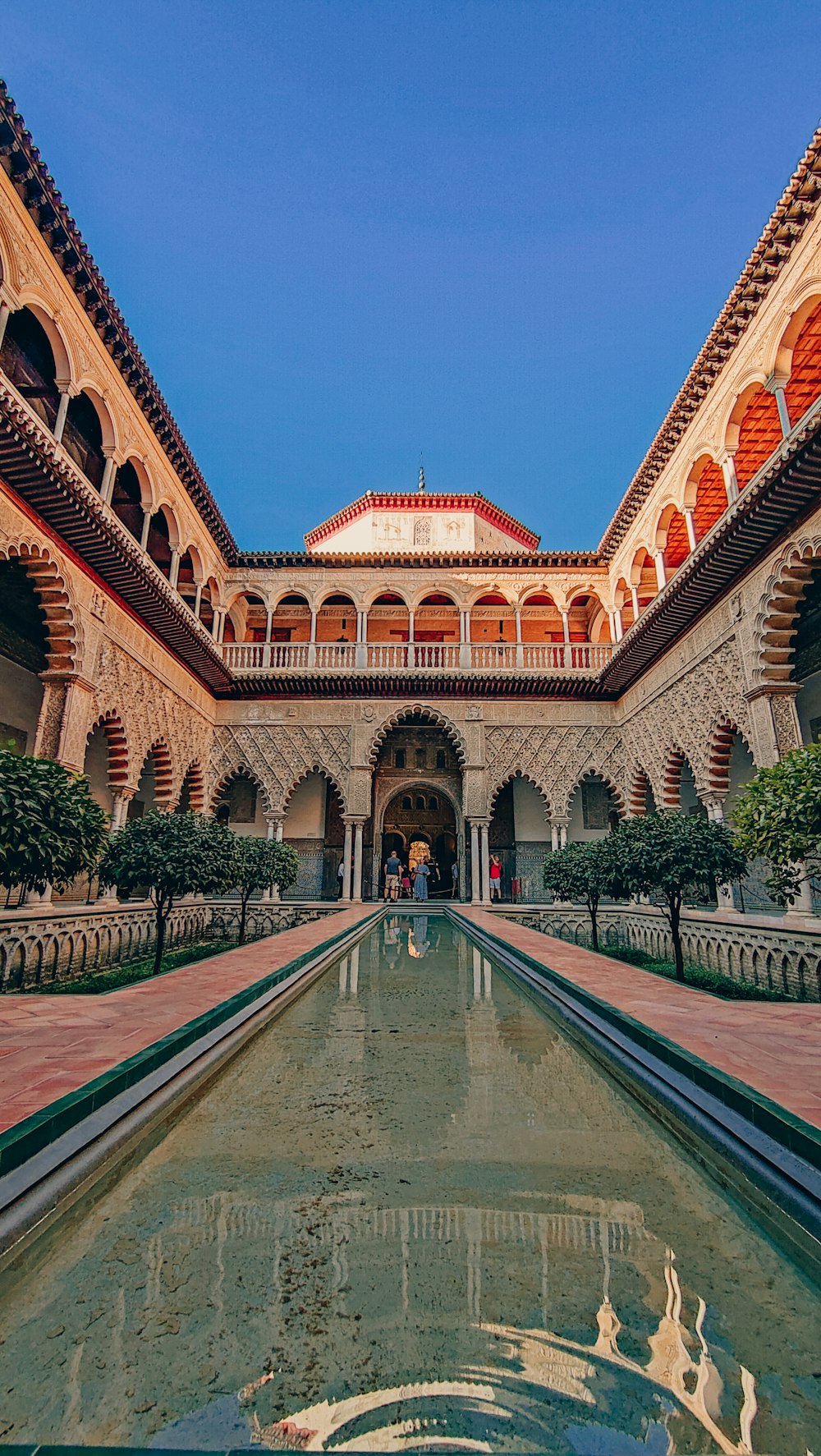 a large building with a pool in front of it