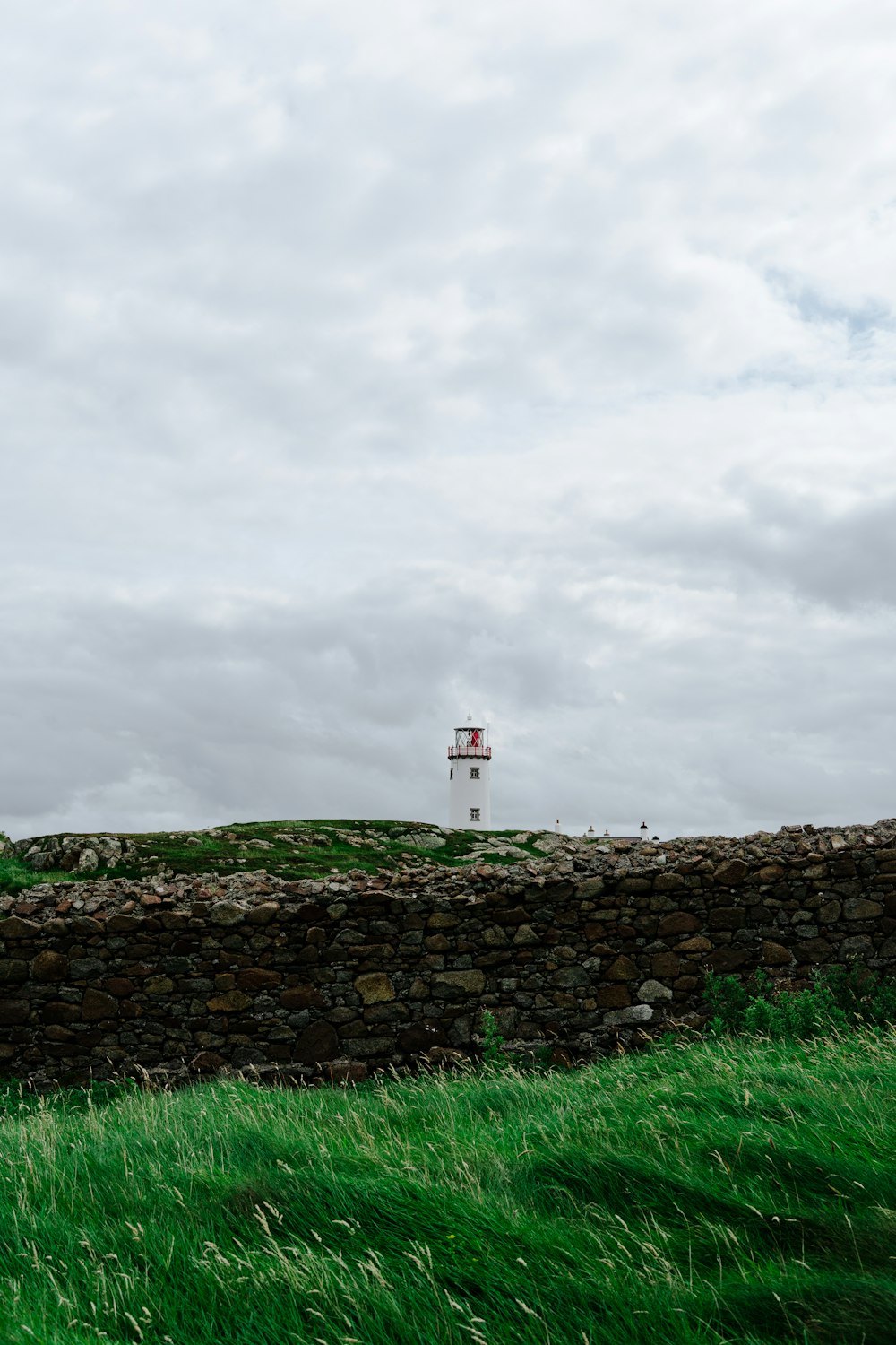 a stone wall with a tower in the distance