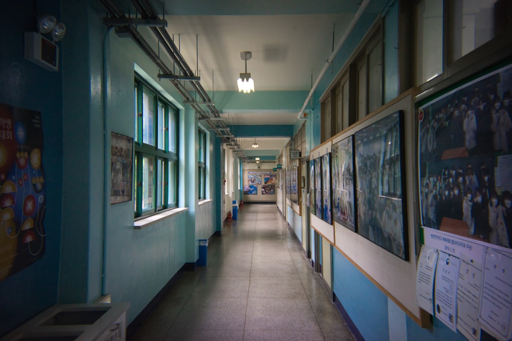 a hallway with many paintings on the walls