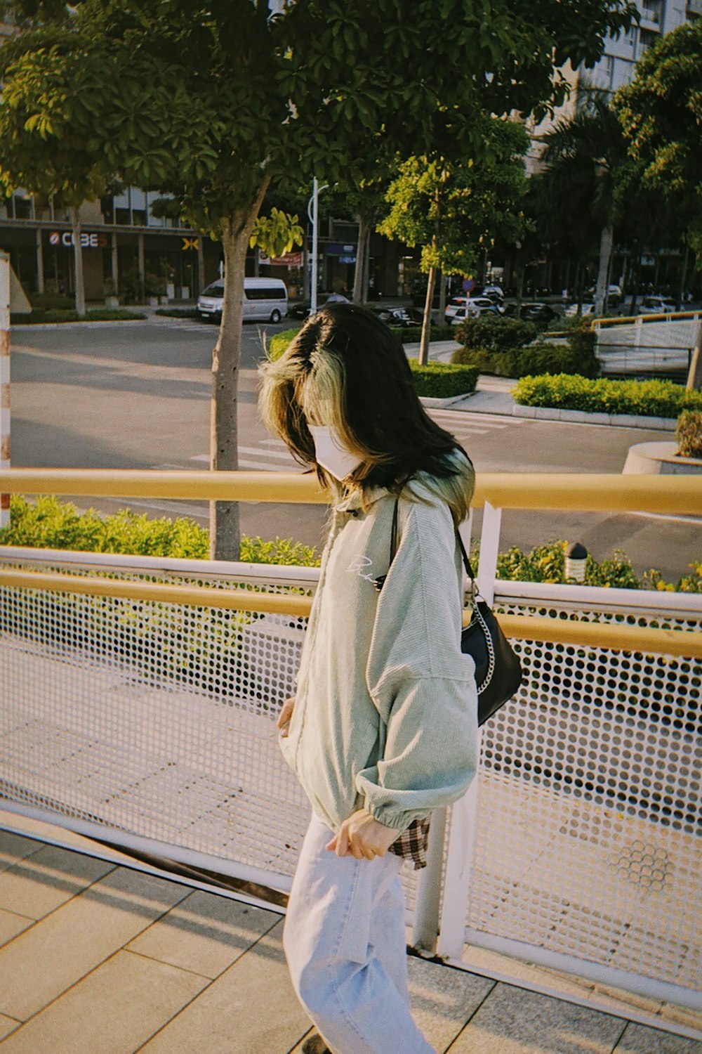 a woman standing on a sidewalk