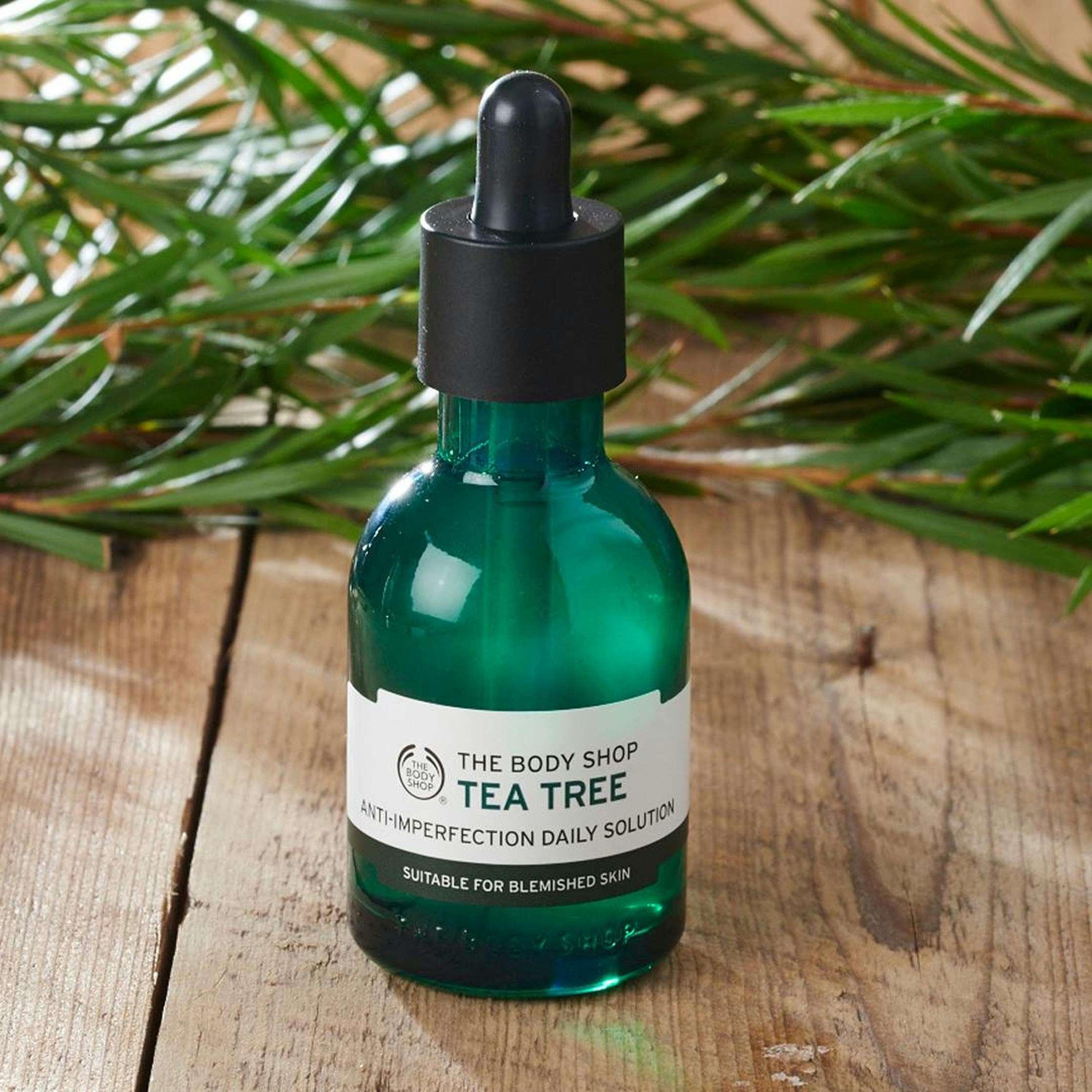 Tea tree toner bottle with green botanical elements