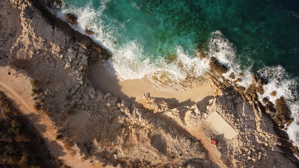 a rocky beach with waves crashing