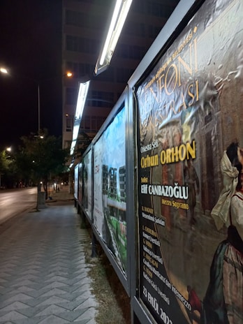 Colorful posters showcasing the 2026 Ealing Book Festival events displayed on a street lamp.