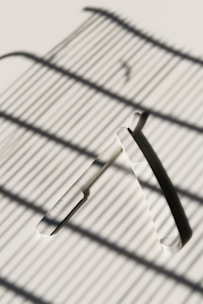 Close-up of sharp razor blades neatly arranged on a wooden surface, highlighting their precision and quality.