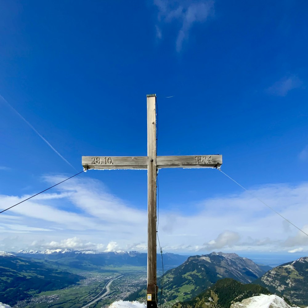 a wooden cross on a mountain