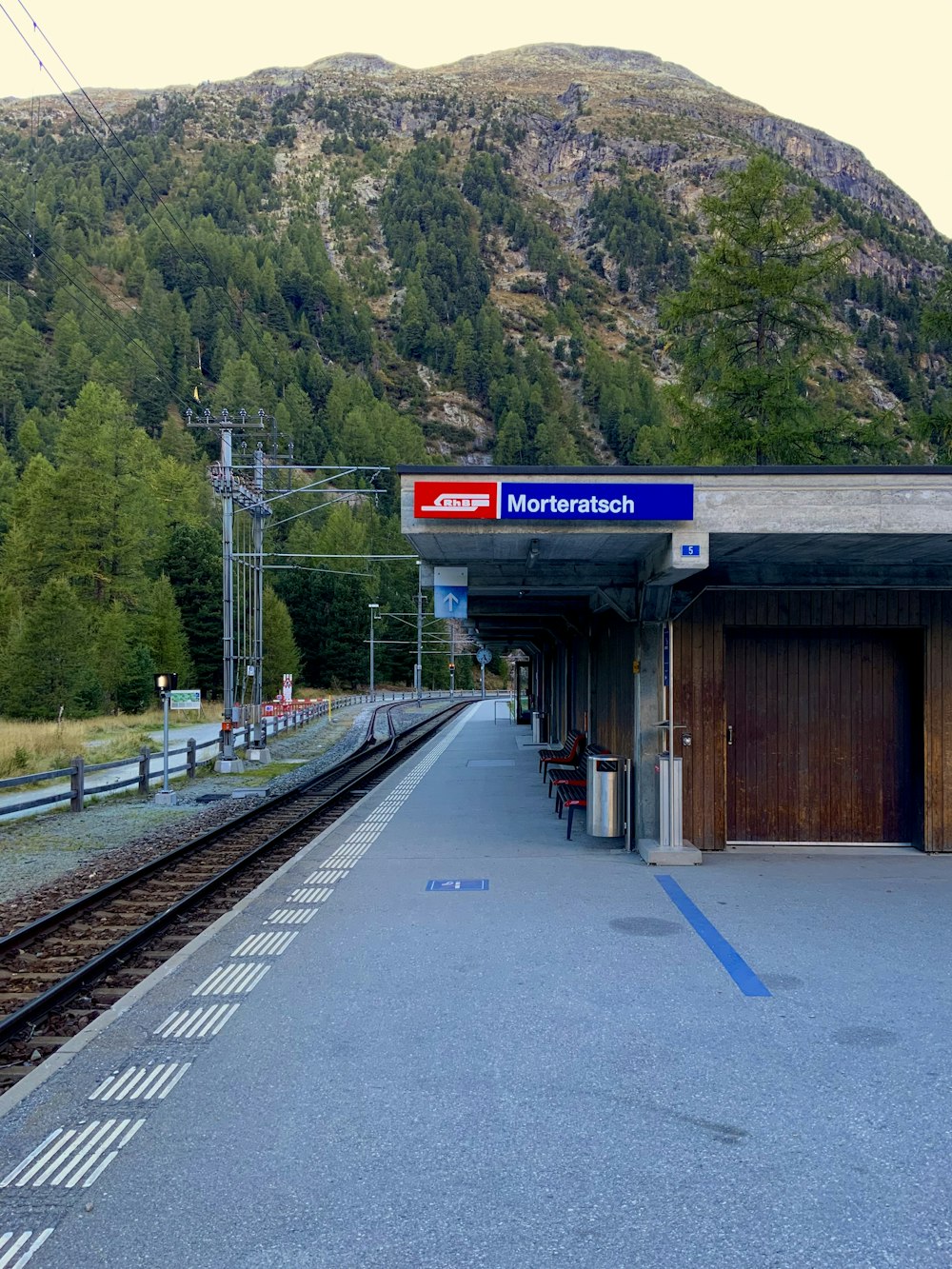 a train station with a mountain in the background