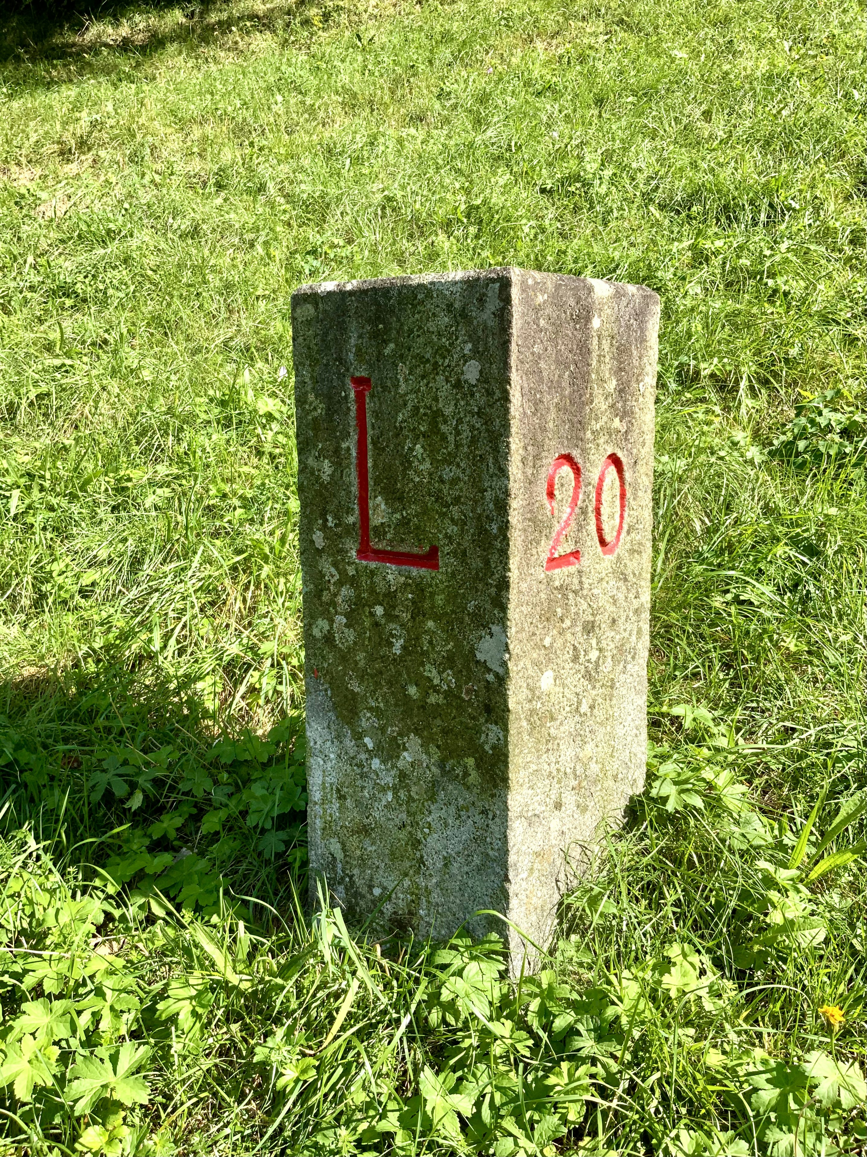 a concrete block with red and white text on it