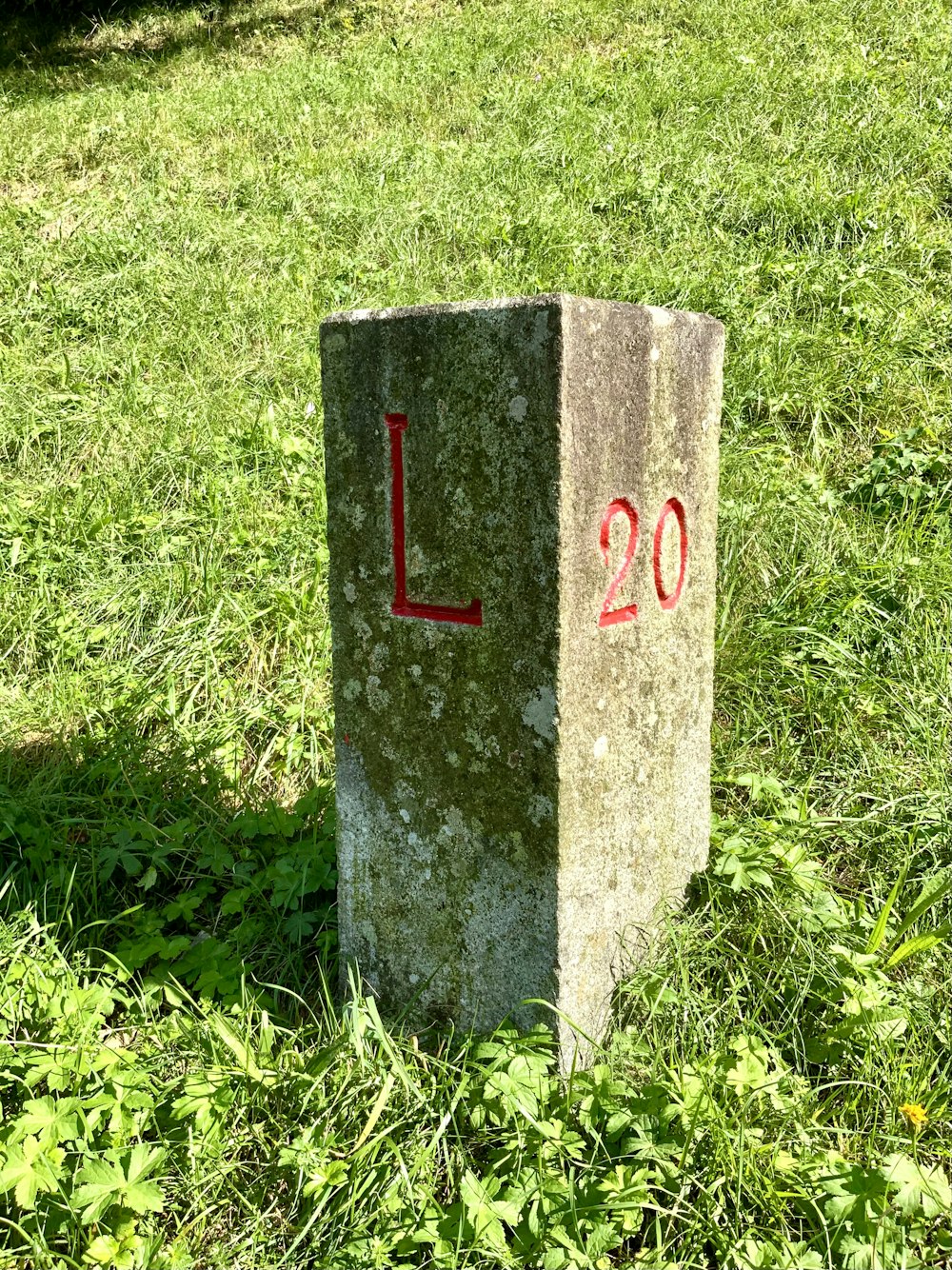 a concrete block with red and white text on it