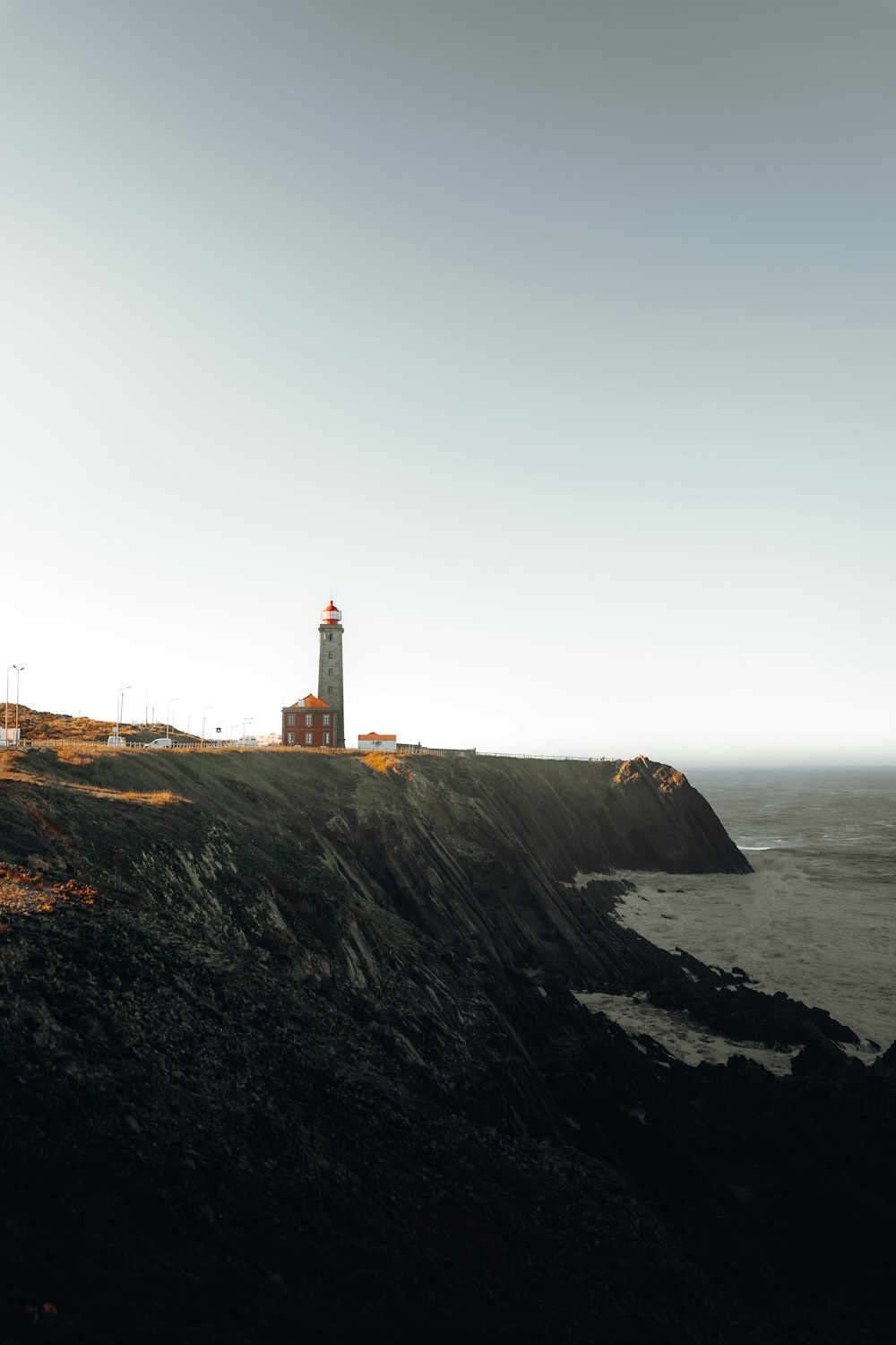 a lighthouse on a rocky hill