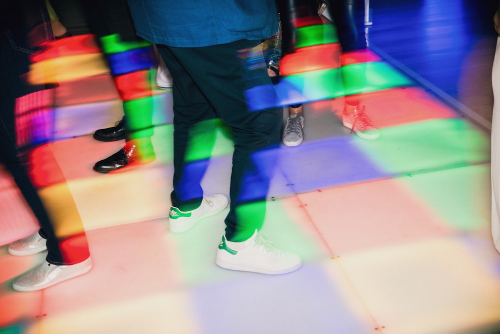 a group of people wearing colorful shoes