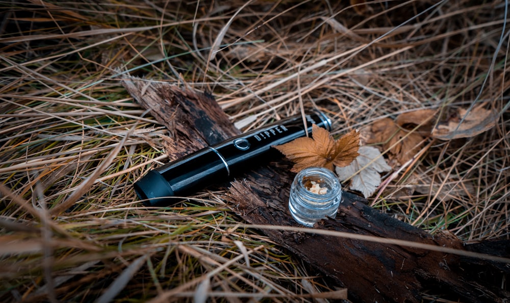 a knife and a bottle of liquid on the ground