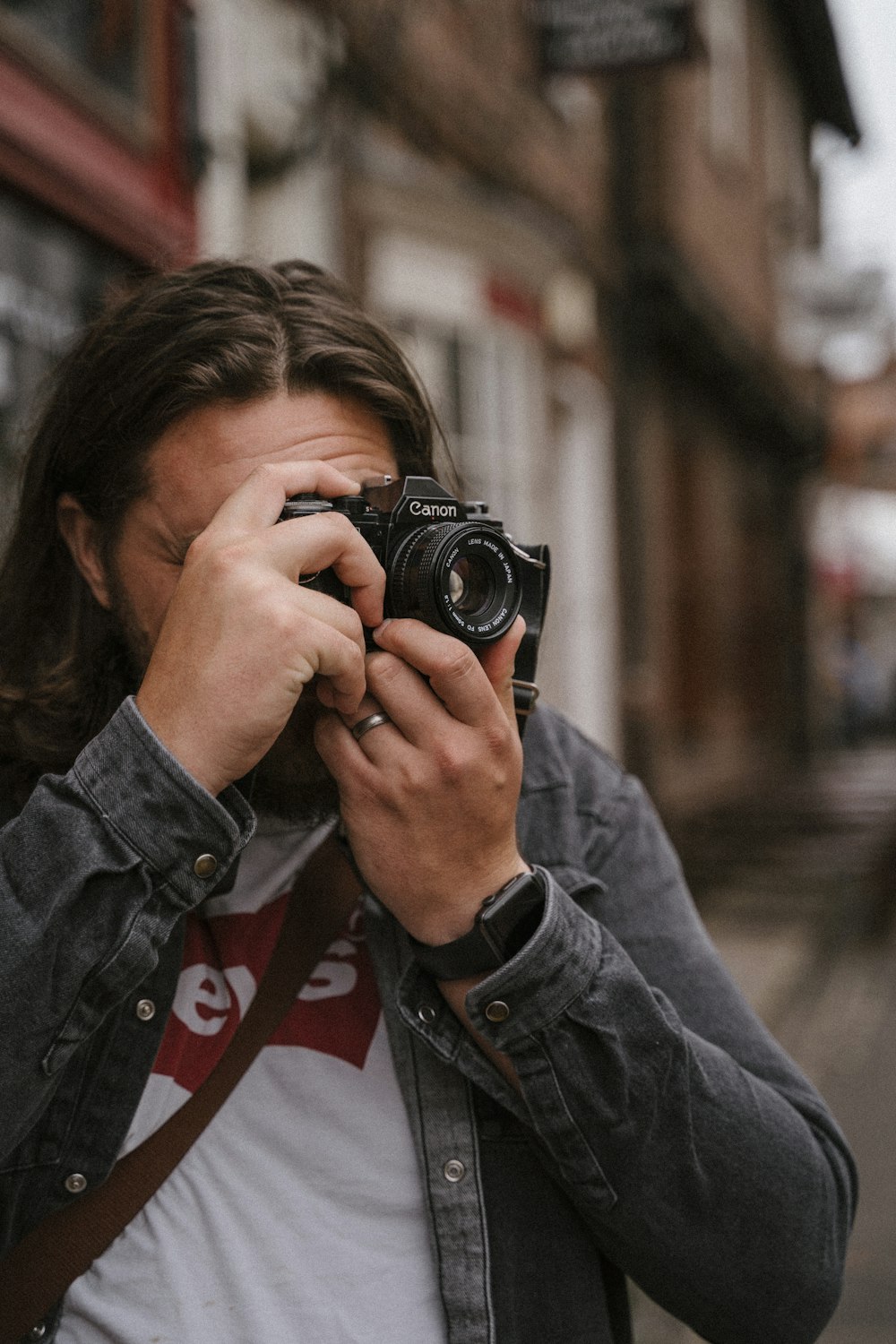 a man holding a camera to his face