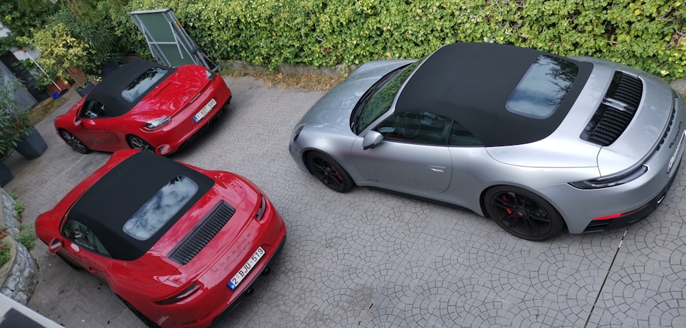 a group of cars parked on a brick road