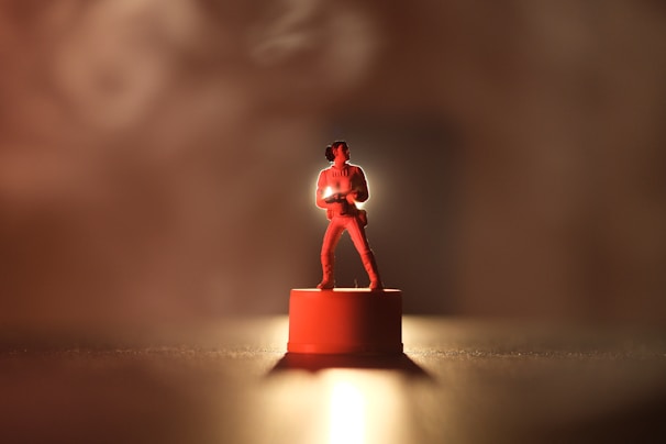 A miniature figurine rotating smoothly on a sleek black pedestal