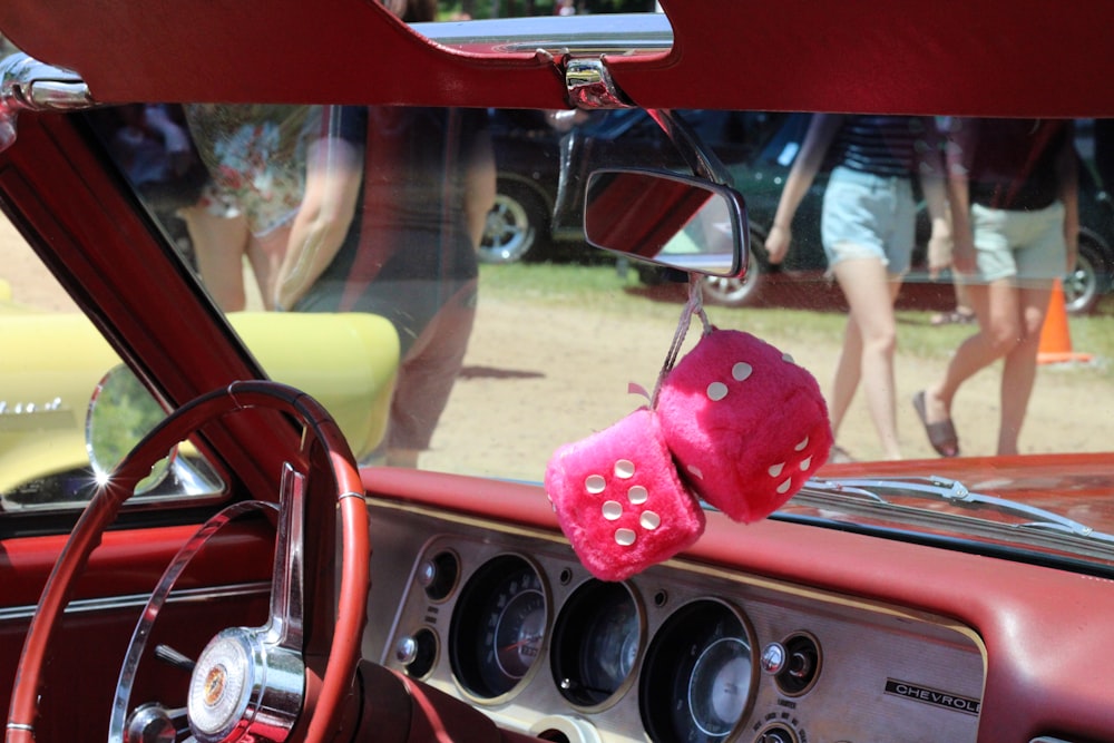 a pink stuffed animal in a car